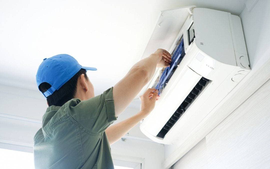Technician repairing an AC unit